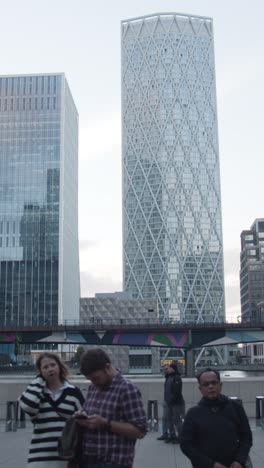 Vertical-Video-Of-Modern-Offices-And-DLR-Rail-Bridge-At-Canary-Wharf-In-London-Docklands-UK-2